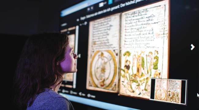 A visitor looking at a digital screen